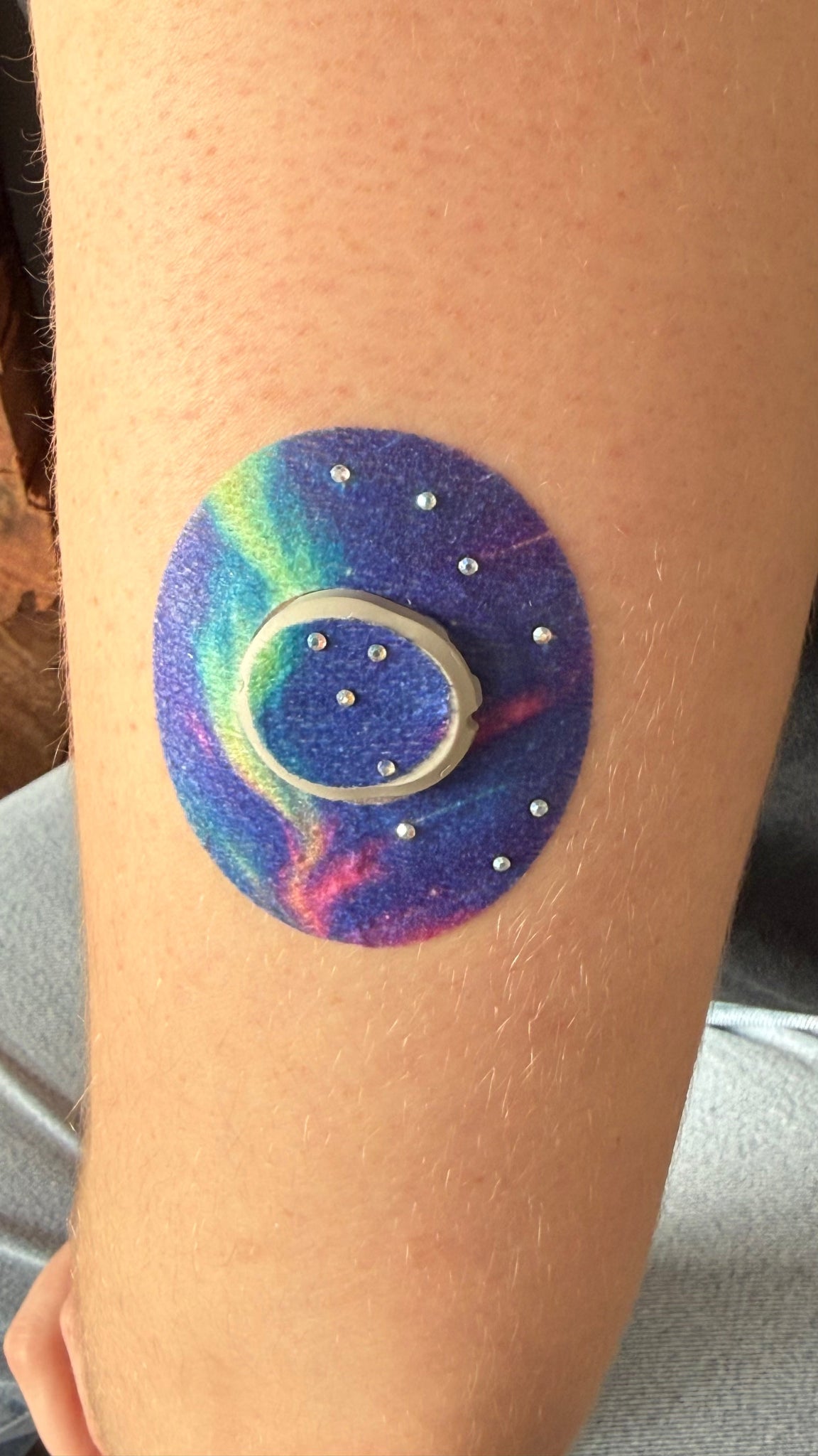 Aurora CGM patch for Dexcom G7 — northern lights with trees on blue purple green background with rhinestone stars applied