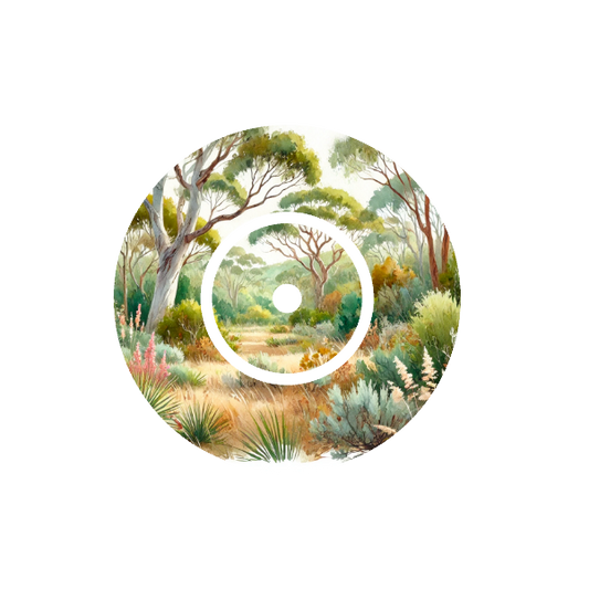 Circular design of watercolour illustration of a Australian landscape with trees and undergrowth on a white background fits CGM FreeStyle Libre 2 device.