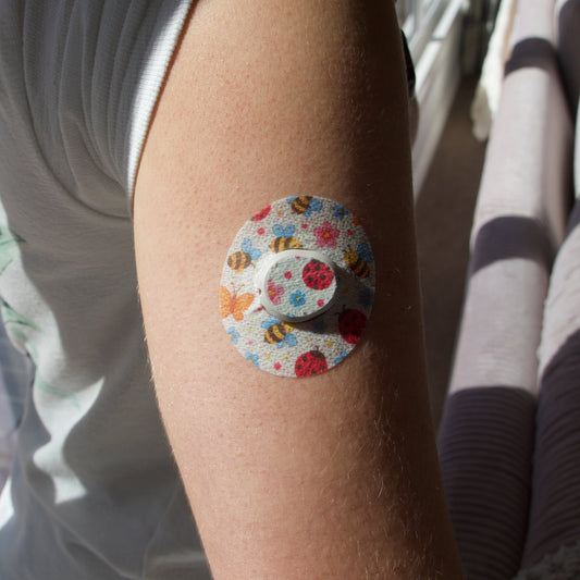 CGM patch .Bugs and Butterflies . Upper arm. Dexcom G7 device.