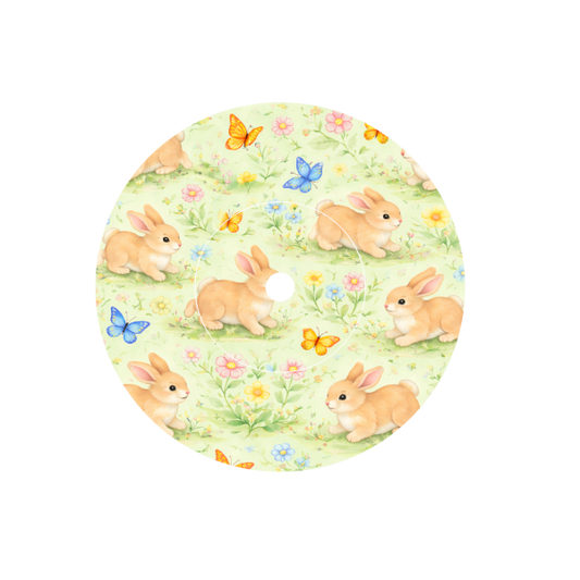 Circular shape soft animated Bunnies playing with butterflies in a meadow of flowers with a cream background fits CGM FreeStyle Libre 2 device.