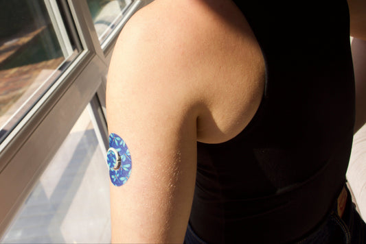 Dragonfly Glimmer CGM patch for Dexcom G7 — dragonflies pattern on dark blue background. Upper Arm .