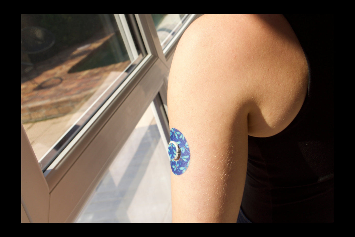 Dragonfly Glimmer CGM patch for Dexcom One+ — dragonflies pattern on dark blue background. Upper Arm .