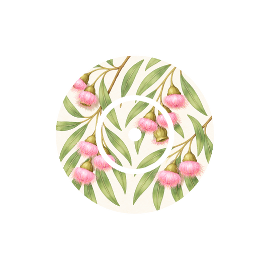 Circular design with soft  pink eucalyptus flowers and green leaves on a white background fits CGM FreeStyle Libre 2 device.
